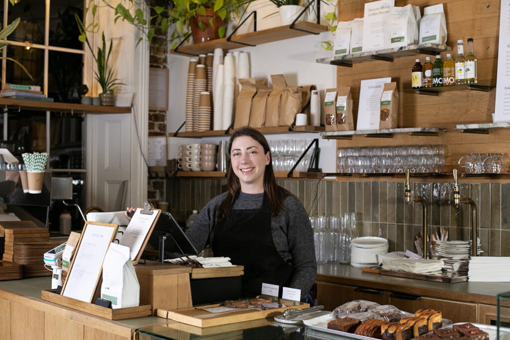 Employee selling pastries and coffee at Boxcar Cafe in Marylebone