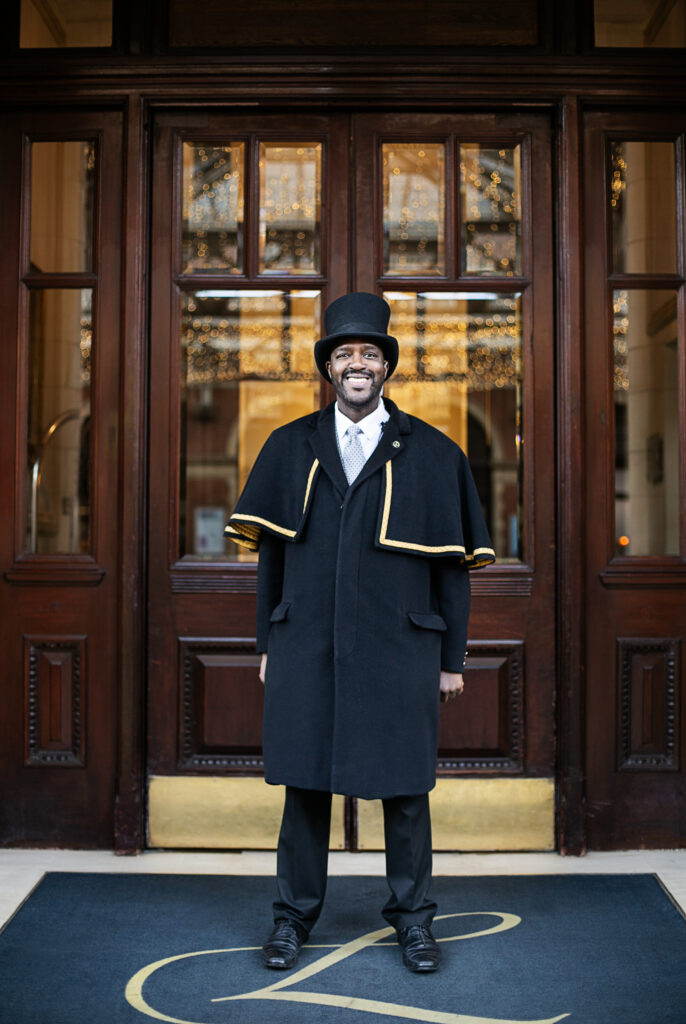 ~Porter stands in front of the entrance of The Landmark hotel London