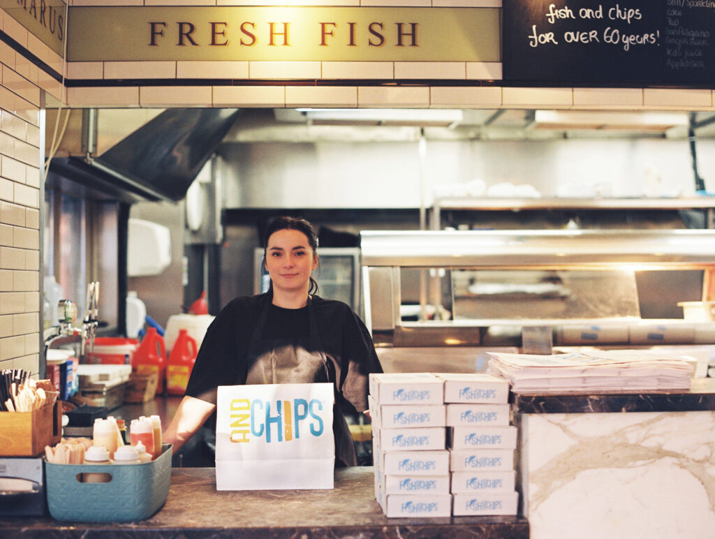 Nataly is standing behind the counter of The Seashell of Lisson Grove, a historical fish and chips shop in Marylebone