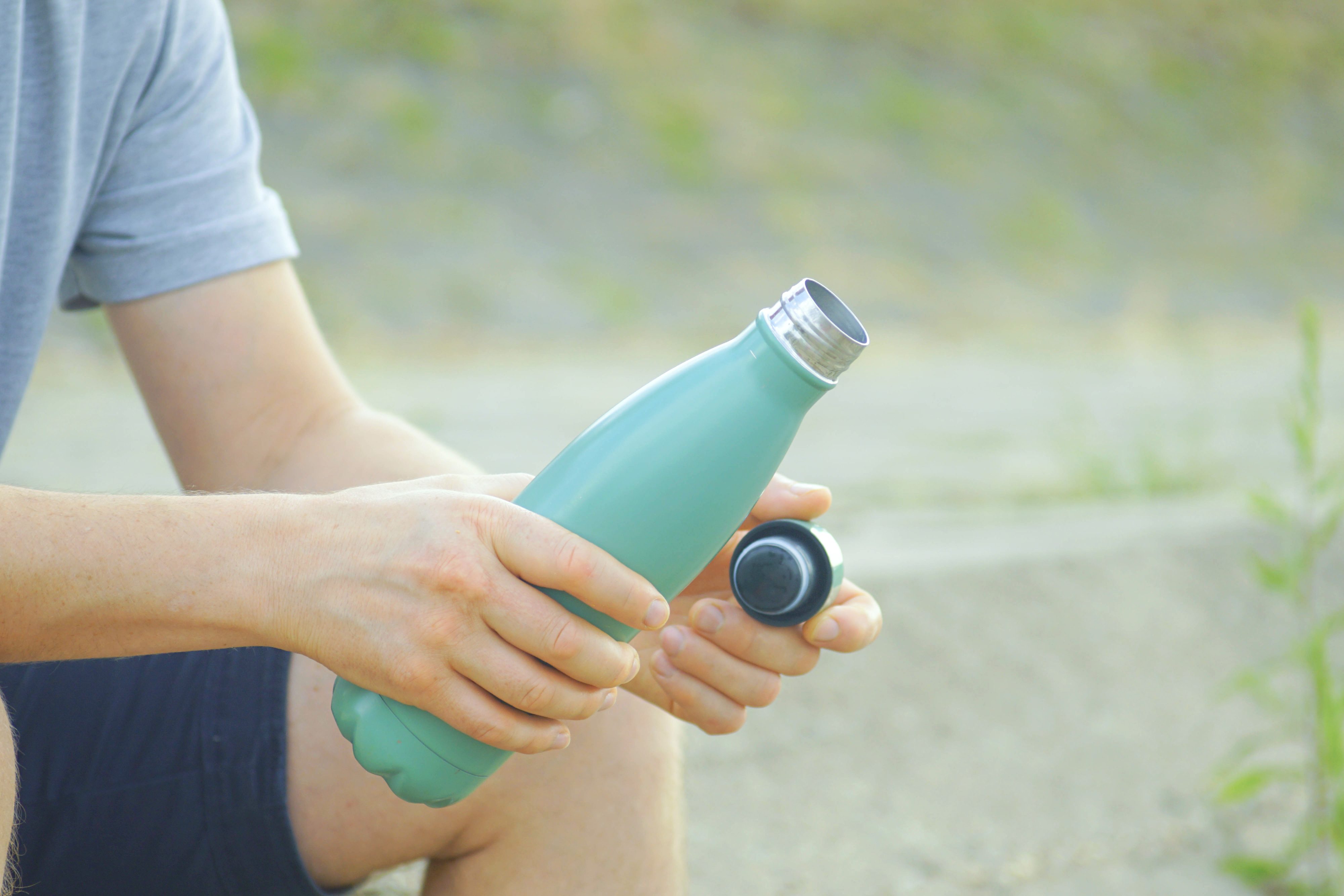 Person taking mindful hydration break away from digital screens outdoors. Digital detox lifestyle and mental wellness pause rituals. Concepts of mindfulness practices, stress relief, work-life balance