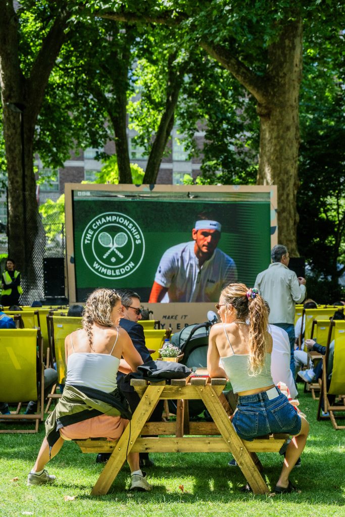 two people enjoyning Summer in the Square event, watching free Wimbledon screening